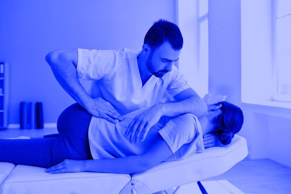 Physiotherapist working on a patients back