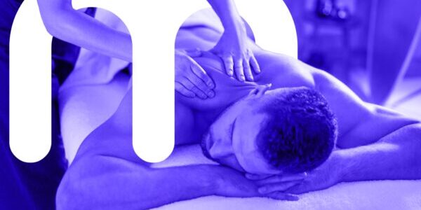 Man receiving massage therapy on shoulders and letter "m"